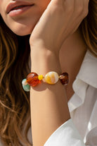 Multicolor resin bead bracelet with marbled stone look worn on wrist
