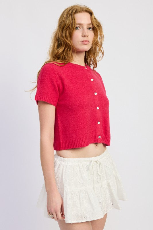 Side view of cropped fuchsia knit cardigan with ribbed hem
