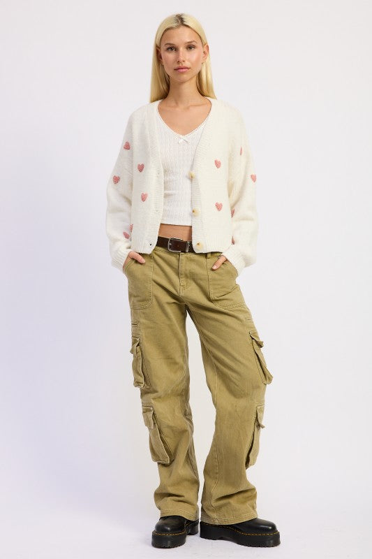 Ivory pink heart cardigan full-length front view styled with cargo pants
