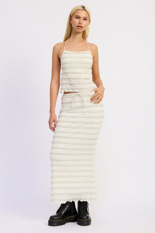 Front view of cream textured maxi skirt with drawstring waist and ruffle detailing
