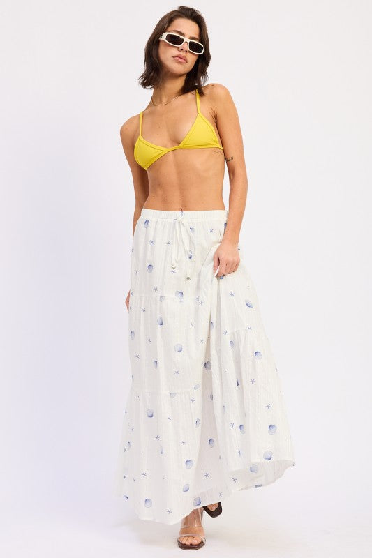 Off white cotton tiered maxi skirt with blue shell and starfish print styled with sandals