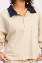 Ivory long sleeve collared top featuring button placket and contrast collar detail

