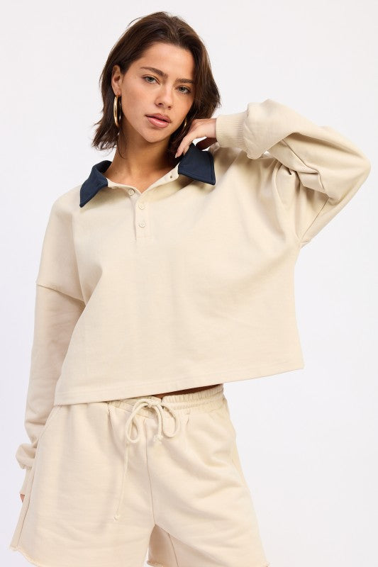 Ivory long sleeve collared top featuring button placket and contrast collar detail
