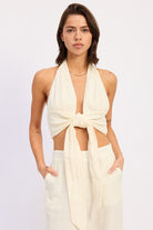 Off white cotton halter top with front tie styled with matching pants