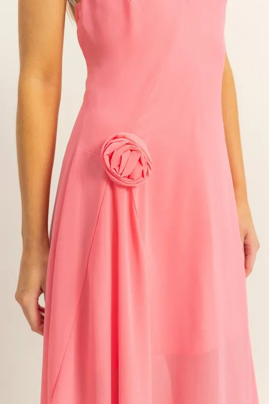 Close up of rosette detail on pink chiffon asymmetrical midi dress
