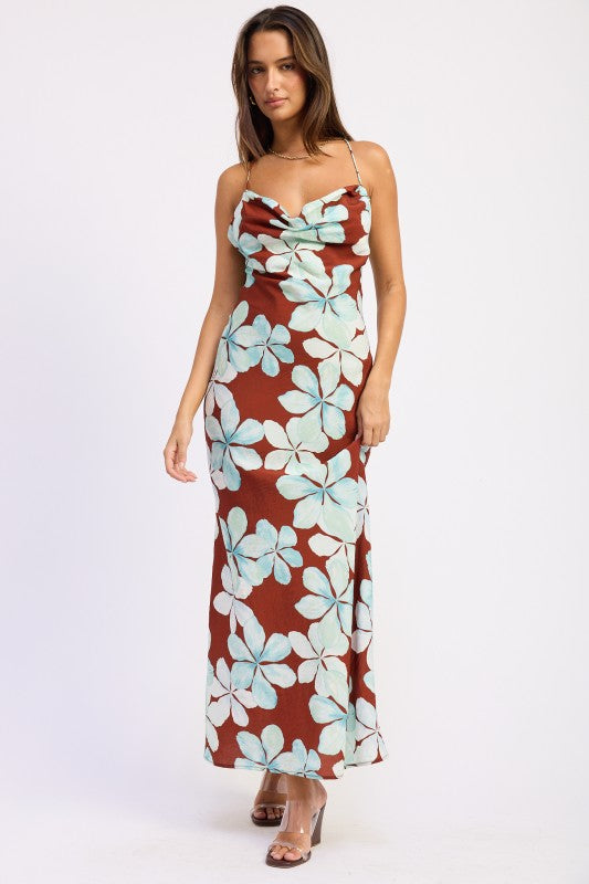 Model wearing rust brown floral maxi dress with aqua blue hibiscus print and cowl neckline front view
