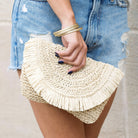 Frayed edge straw clutch with lined interior in Natural color