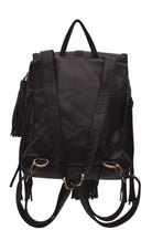 Black leather backpack with gold-tone hardware, featuring dual top handles, a detachable shoulder strap, and fringe tassels on the sides and bottom, shown against a plain white background.