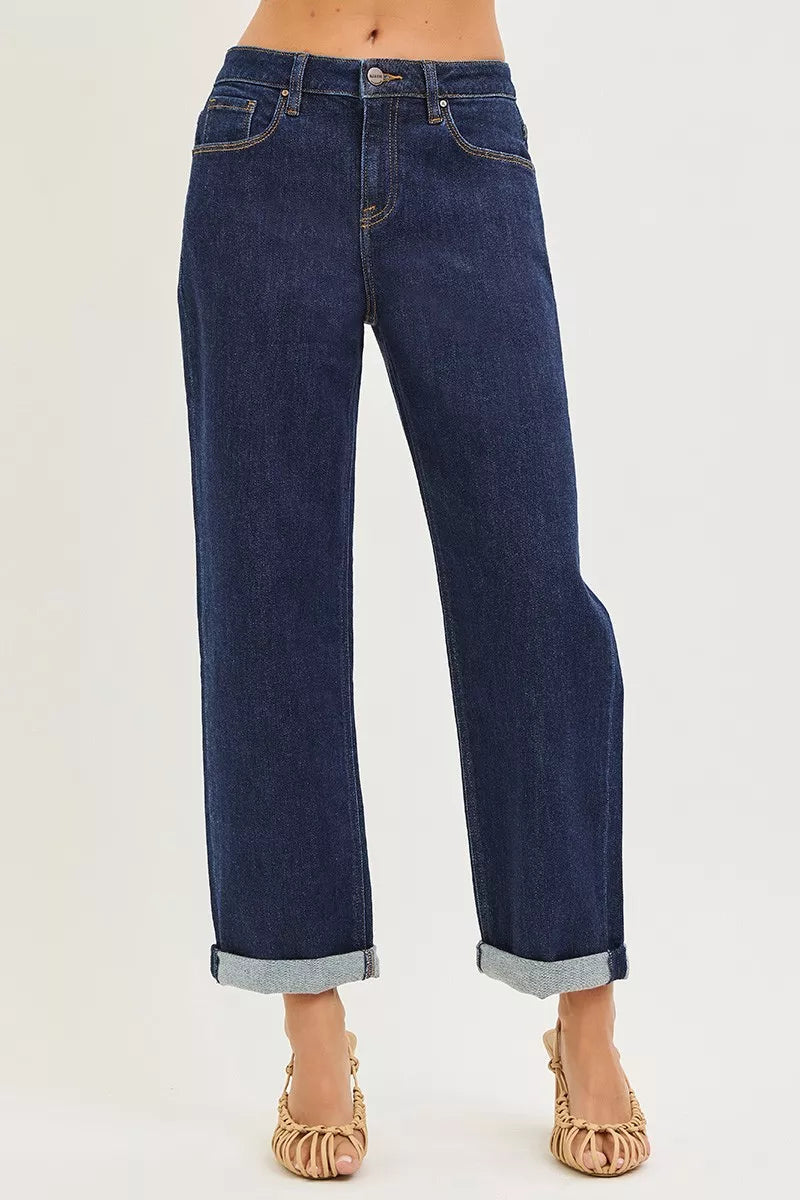 Dark indigo cuffed wide leg jeans showing cropped length and five pocket design
