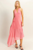 Pink asymmetrical chiffon midi dress with plunging halter neckline and draped rosette detail

