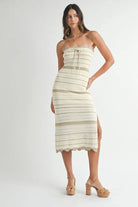 Model wearing light taupe crochet midi dress with scalloped trim
