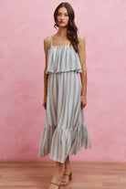 Front view of a blue stripe tie shoulder maxi dress with a square neckline and flowing layered bodice.