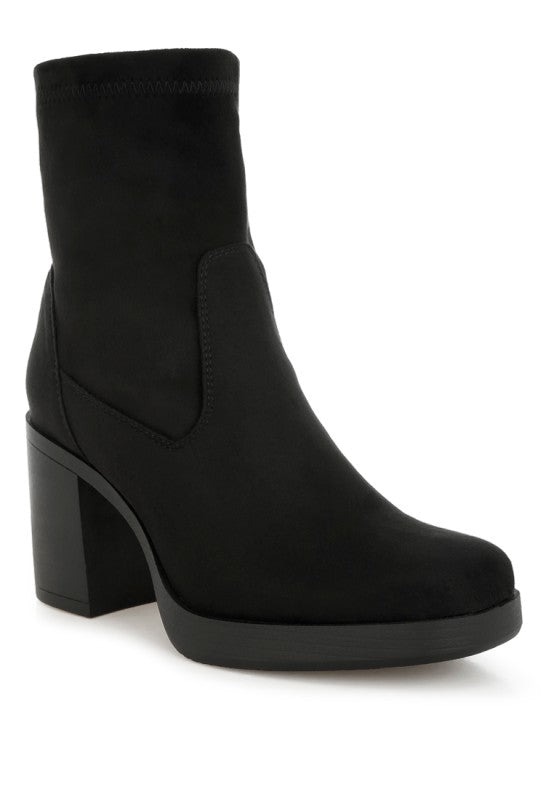 Black version of platform boot, side view.
