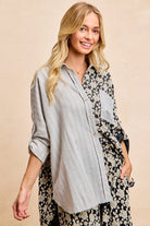 Florence floral and striped button down shirt with rolled sleeve and oversized relaxed silhouette.