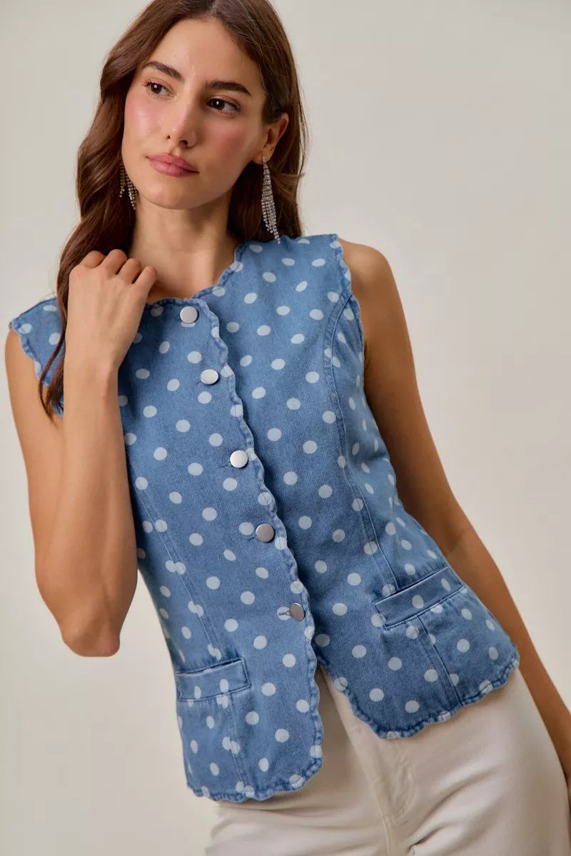 Sleeveless polka dot denim vest with snap button front closure
