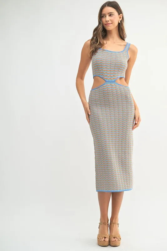 Model wearing colorful striped knit midi dress with side cutouts
