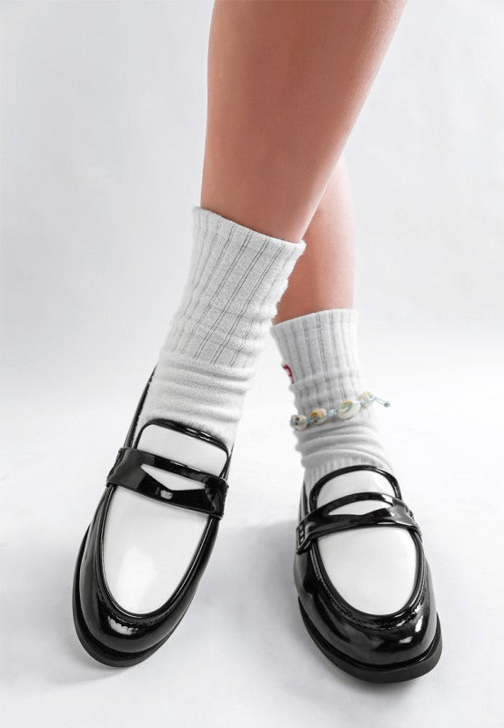 Close up view of black and white penny loafers 