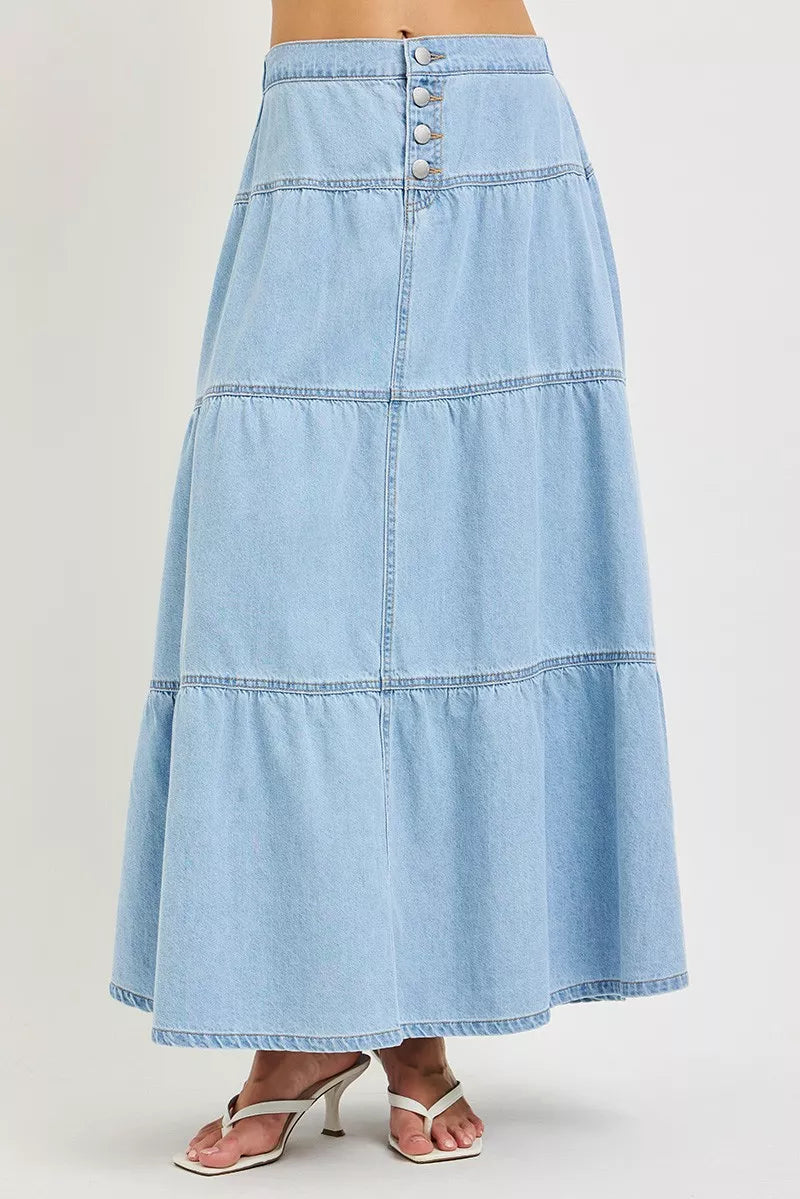 Front view of light blue tiered denim maxi skirt with button front detail
