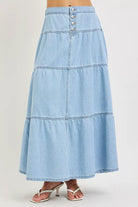Front view of light blue tiered denim maxi skirt with button front detail
