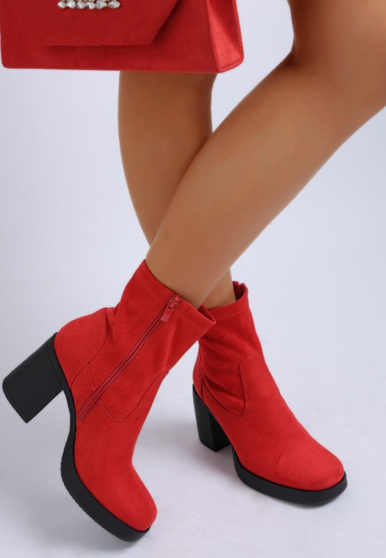 Side view of red square-toe boots with block heel.

