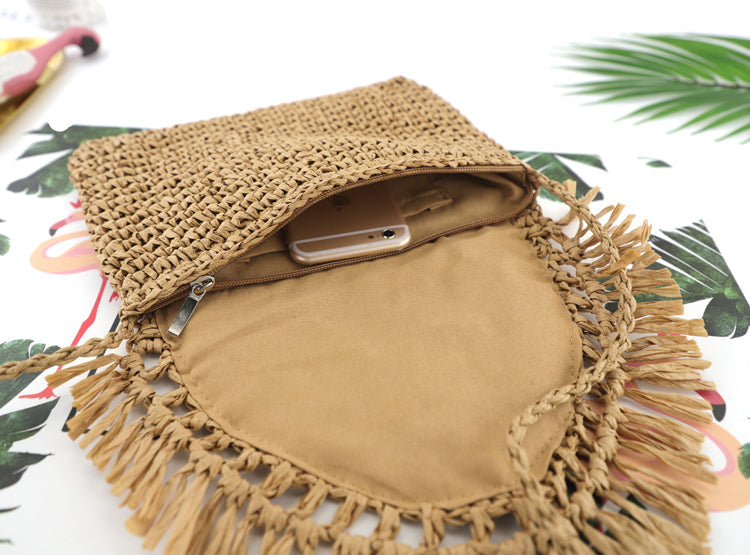 khaki woven straw crossbody with fringe flap detail, styled inside view-AVAH