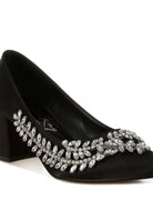 Close-up of black satin pointed-toe heel with crystals
