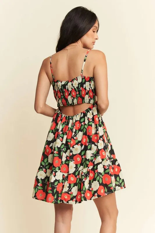 Back view of floral mini dress with smocked back and cutout detail
