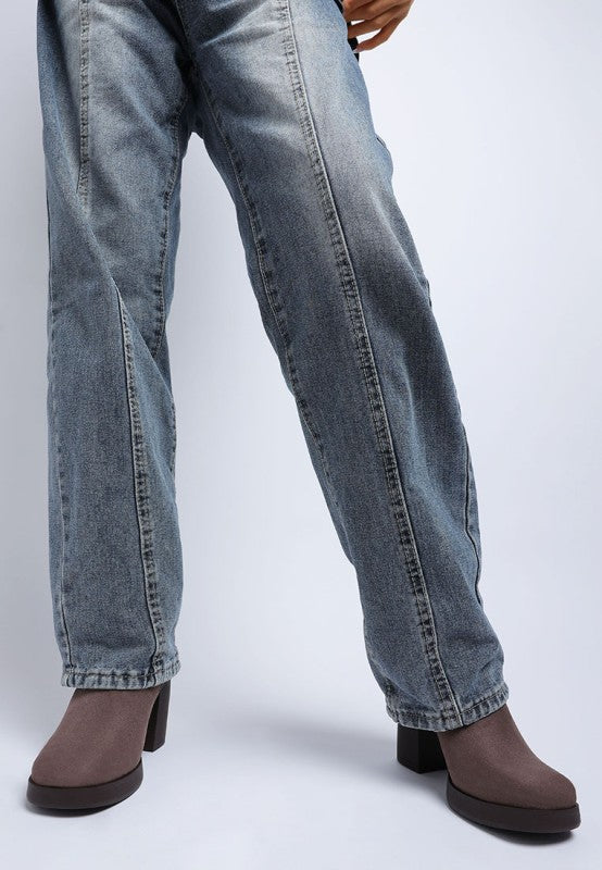 Blue jeans worn by a model on a white background
