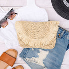Frayed edge straw clutch with lined interior in Natural color