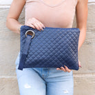 Navy quilted clutch made with a premium soft quilted PU leather and cotton Herringbone print lining with grommet detail and wristlet.