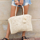 Nomadic Natura Straw Tote with artisan weave and pom-pom in straw front view
