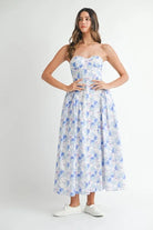 Blue floral strapless midi dress featuring a sweetheart neckline, fitted bodice, and full flowing skirt.