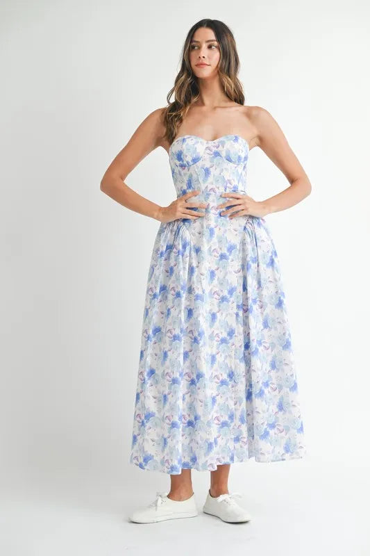 Blue floral strapless midi dress featuring a sweetheart neckline, fitted bodice, and full flowing skirt.