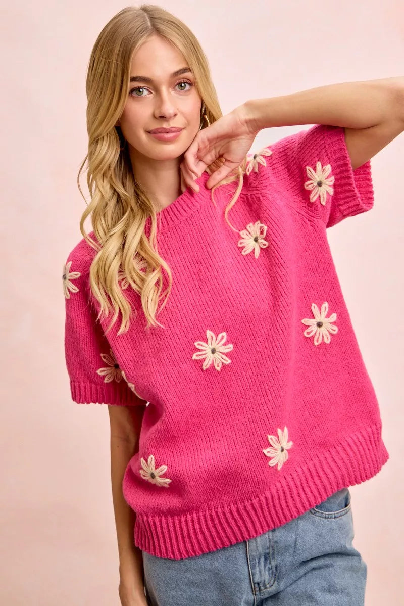 Pink daisy embroidered short sleeve sweater with crew neckline and ribbed trim
