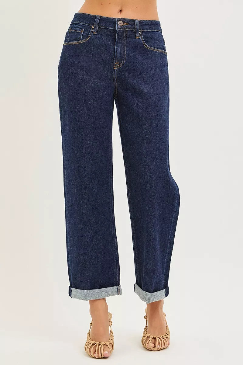 Dark indigo cuffed wide leg jeans showing cropped length and five pocket design
