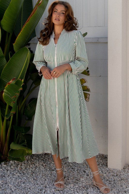 Full-length view of green striped shirt dress styled with lace-up sandals.