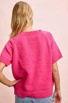 Back view of pink daisy embroidered short sleeve sweater with crew neckline and ribbed trim