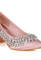 Close-up of blush satin pointed-toe heel with crystals
