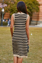 Back view of sleeveless striped knit midi dress showing fitted silhouette.
