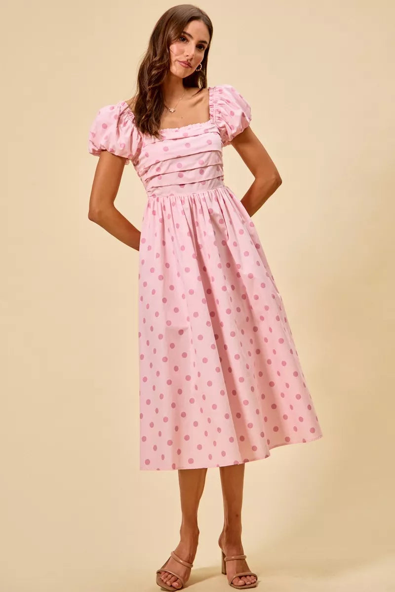 Front view of pink polka dot midi dress with square neckline, puff sleeves, and fitted bodice | AVAH Collections
