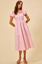 Front view of pink polka dot midi dress with square neckline, puff sleeves, and fitted bodice | AVAH Collections

