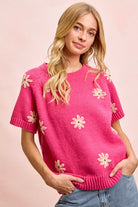 Pink daisy embroidered short sleeve sweater with crew neckline and ribbed trim
