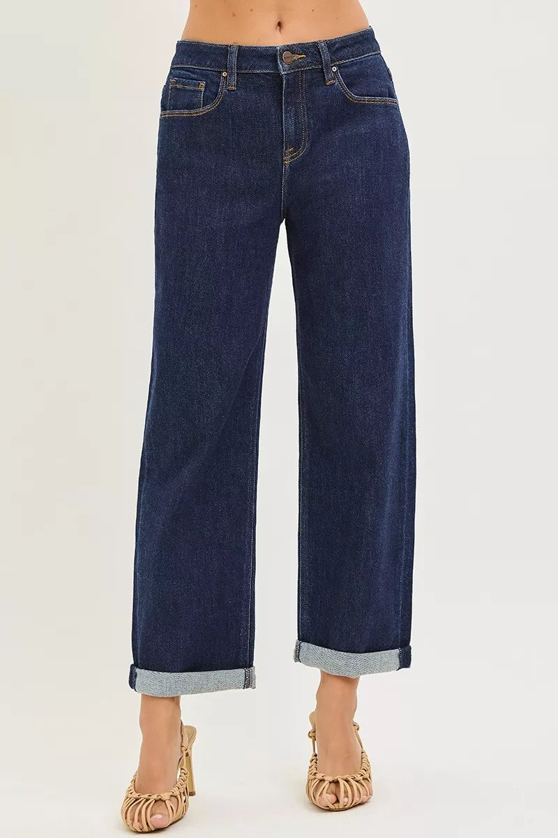 Dark indigo cuffed wide leg jeans showing cropped length and five pocket design, front view
