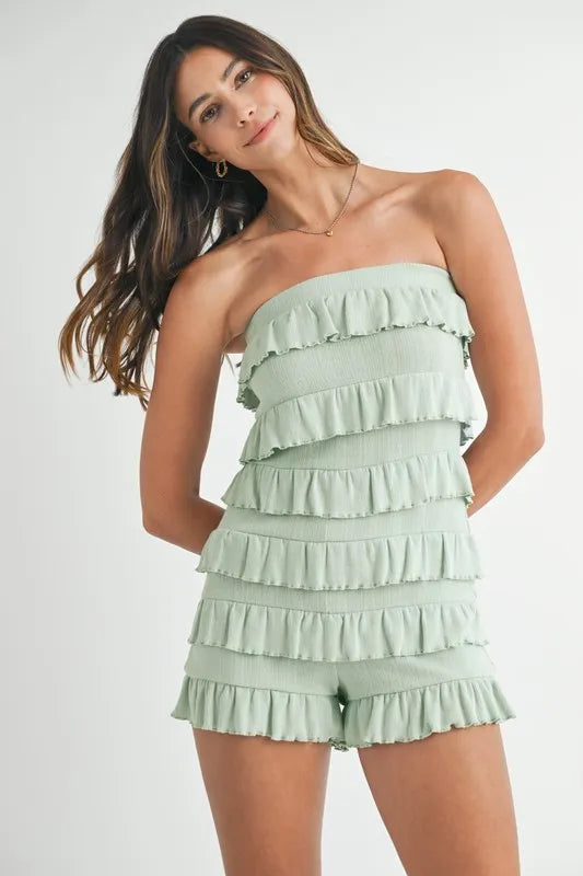 Front view of sage green strapless ruffle romper
