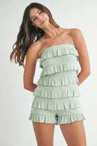 Front view of sage green strapless ruffle romper
