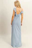 Back view of blue chiffon ruffle maxi dress with low scoop back and asymmetrical neckline
