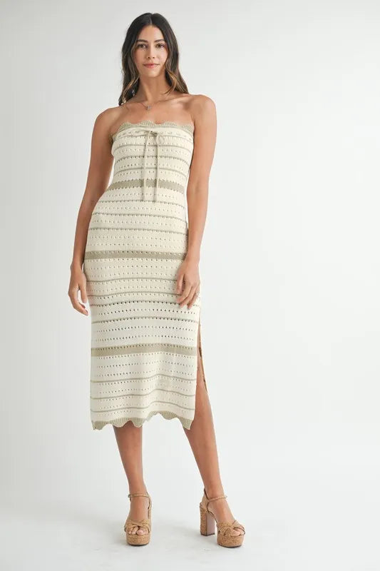 Model wearing  strapless crochet midi dress with scalloped trim
