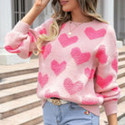 Blush pink heart textured knit sweater front view styled with light wash jeans
