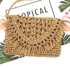 close up of khaki woven straw crossbody with fringe flap detail, styled with a white blouse and denim shorts-AVAH