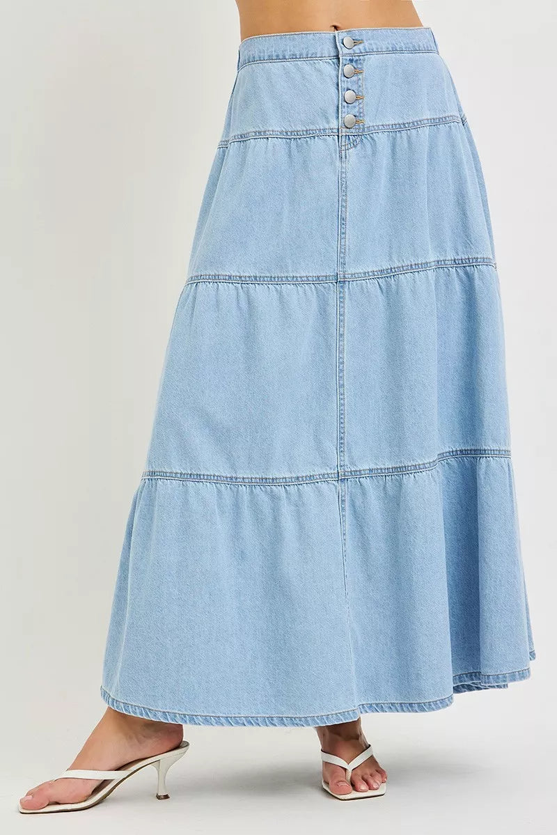 Front view of light blue tiered denim maxi skirt with button front detail
